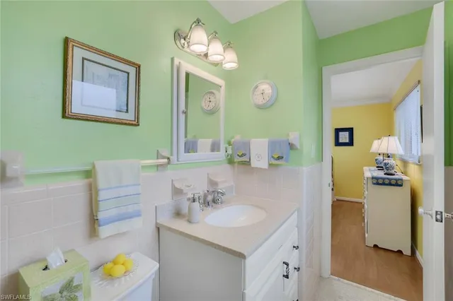 a bathroom with a sink vanity and a mirror