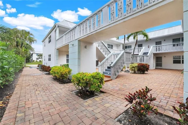 a view of a house with potted plants