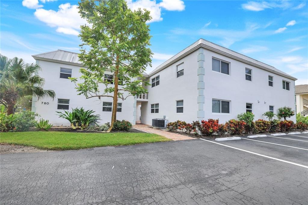 780 10th Avenue South, Unit 22 Naples, FL 34102 - Photo 4 of 17 a view of a house with a yard and plants