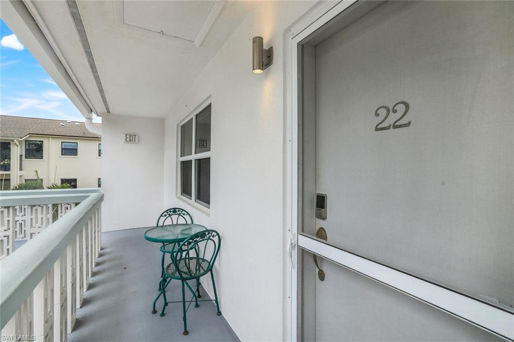 780 10th Avenue South, Unit 22 Naples, FL 34102 - Photo 5 of 17 a balcony with table and chairs