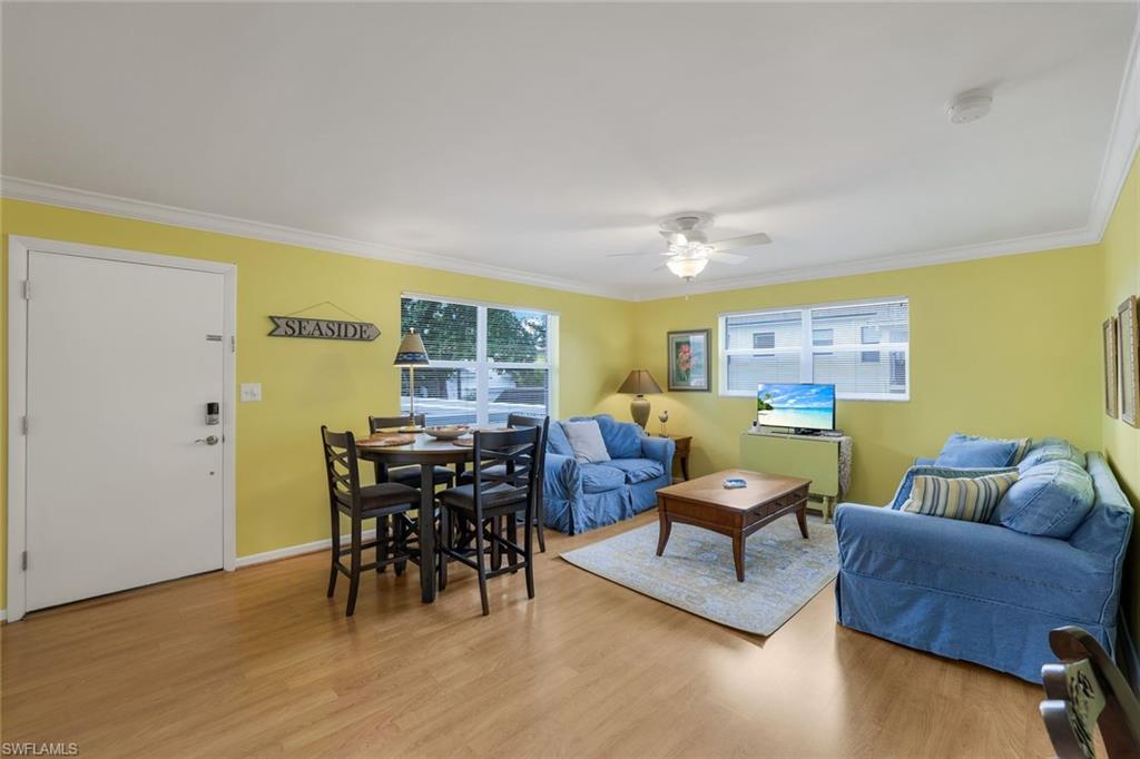 780 10th Avenue South, Unit 22 Naples, FL 34102 - Photo 6 of 17 a living room with furniture and wooden floor