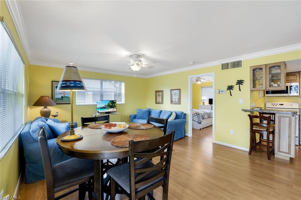 780 10th Avenue South, Unit 22 Naples, FL 34102 - Photo 8 of 17 a view of a dining room with furniture and wooden floor