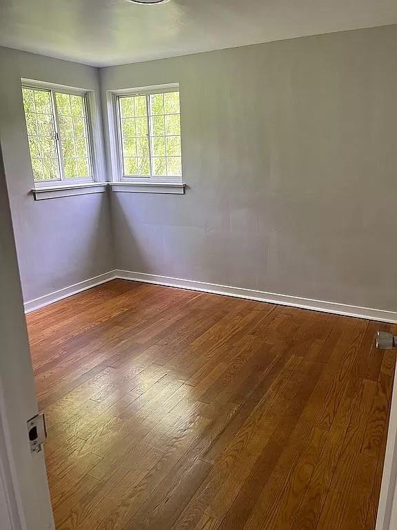 330 Beulah Road Pittsburgh, PA 15235 - Photo 18 of 24 a view of an empty room with wooden floor and a window