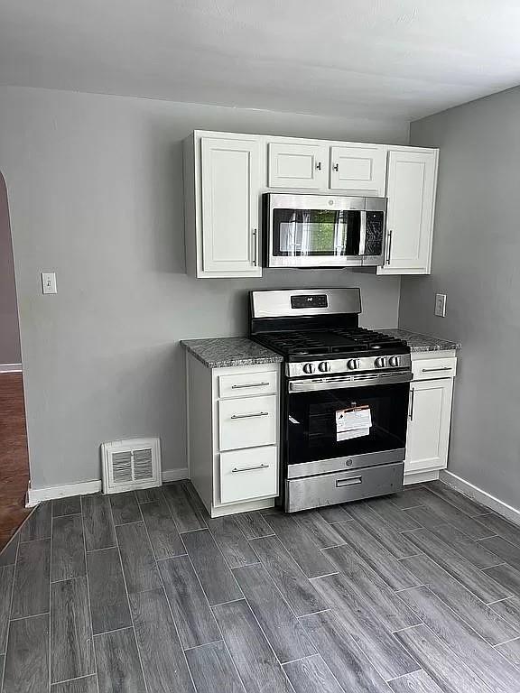 330 Beulah Road Pittsburgh, PA 15235 - Photo 8 of 24 a kitchen with stainless steel appliances a stove top oven and cabinets
