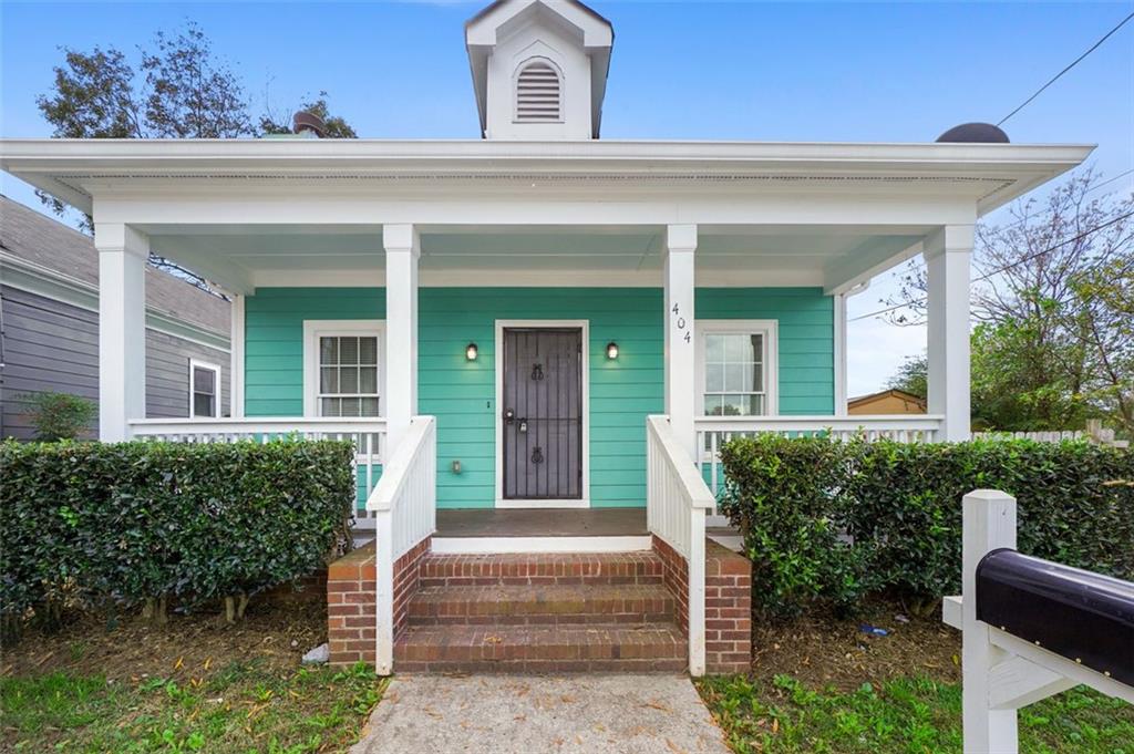 404 Bass Street Southwest Atlanta, GA 30310 - Photo 1 of 1 a front view of a house with porch