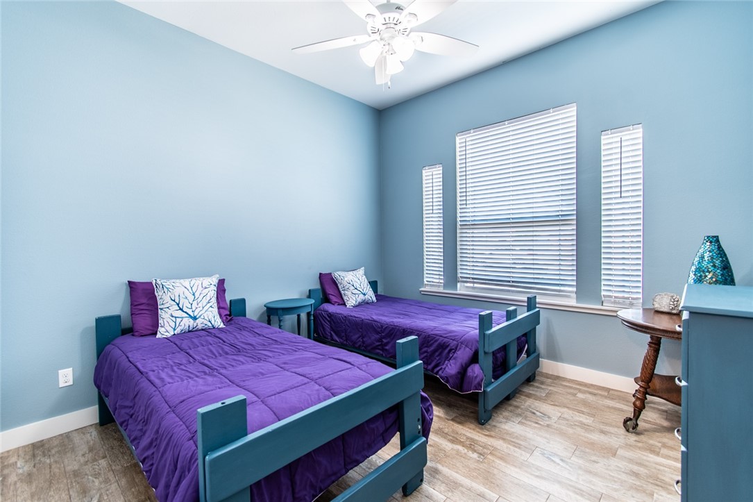 15422 Dyna Street Corpus Christi, TX 78418 - Photo 13 of 40 a bedroom with two beds and a window