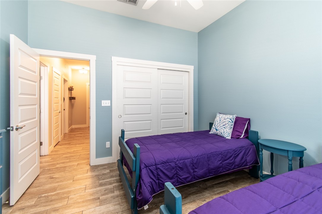 15422 Dyna Street Corpus Christi, TX 78418 - Photo 14 of 40 a bedroom with a bed and wooden floor