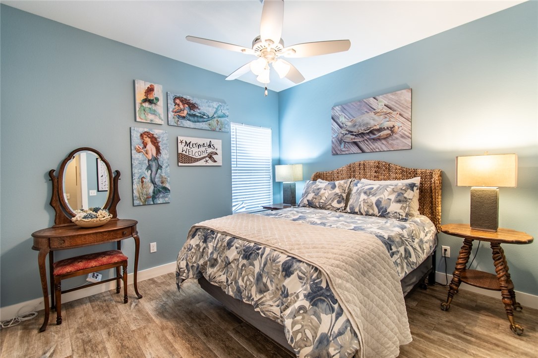 15422 Dyna Street Corpus Christi, TX 78418 - Photo 15 of 40 a bedroom with a bed and a chandelier