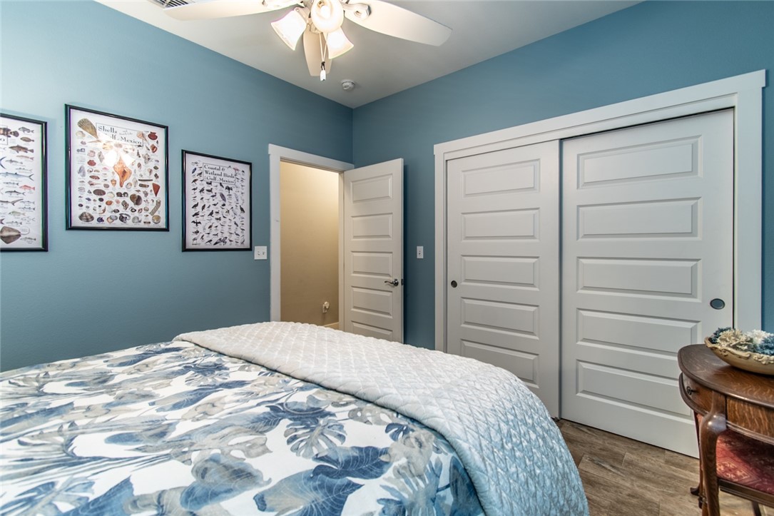 15422 Dyna Street Corpus Christi, TX 78418 - Photo 16 of 40 a bedroom with a bed and a chandelier