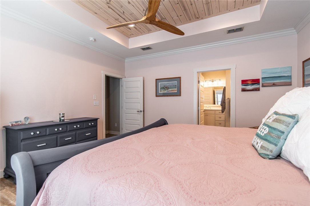 15422 Dyna Street Corpus Christi, TX 78418 - Photo 19 of 40 a bedroom with a bed and dresser with mirror