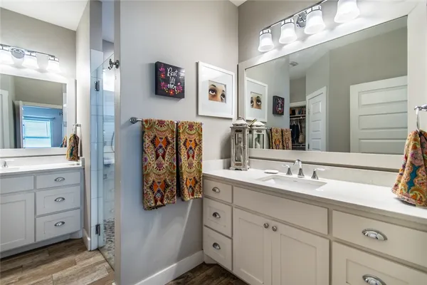 a bathroom with a double vanity sink and a mirror