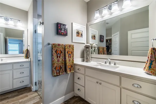 a bathroom with a double vanity sink and a mirror