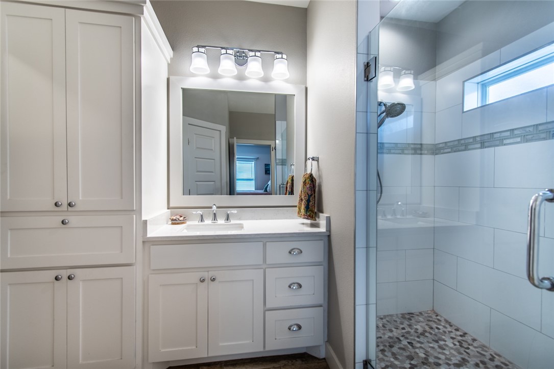 15422 Dyna Street Corpus Christi, TX 78418 - Photo 21 of 40 a bathroom with a sink and a mirror