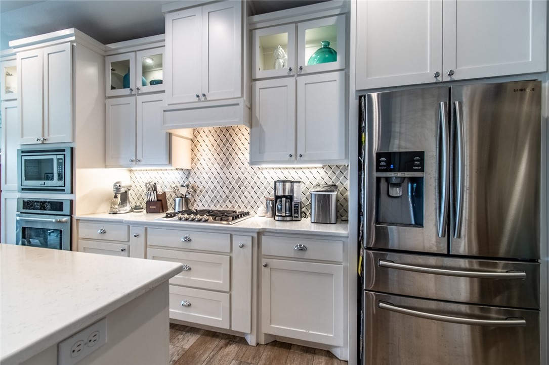 15422 Dyna Street Corpus Christi, TX 78418 - Photo 31 of 40 a kitchen with stainless steel appliances a refrigerator sink and cabinets