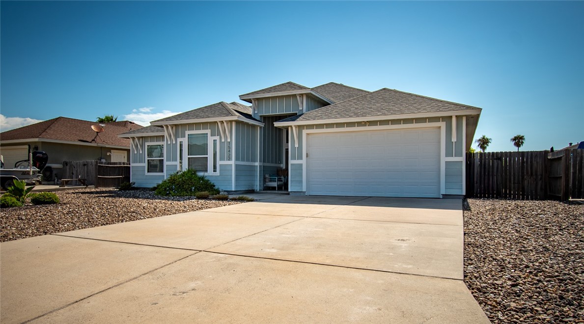 15422 Dyna Street Corpus Christi, TX 78418 - Photo 5 of 40 a front view of a house with a yard and garage