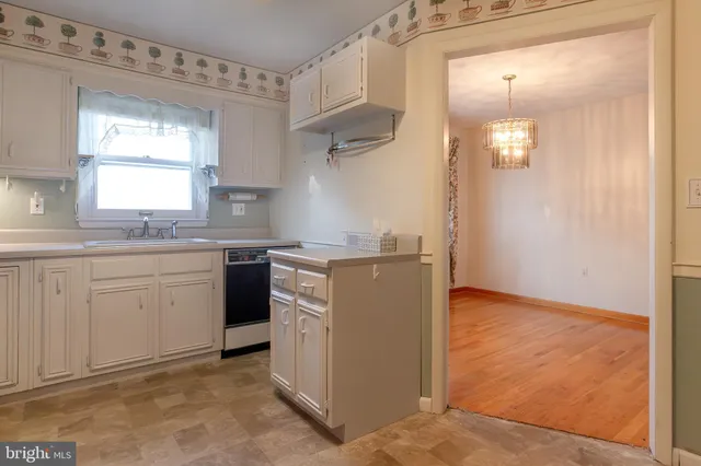 a kitchen with a sink cabinets and a window