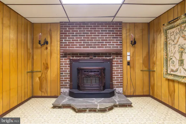 a view of empty room with windows and fireplace