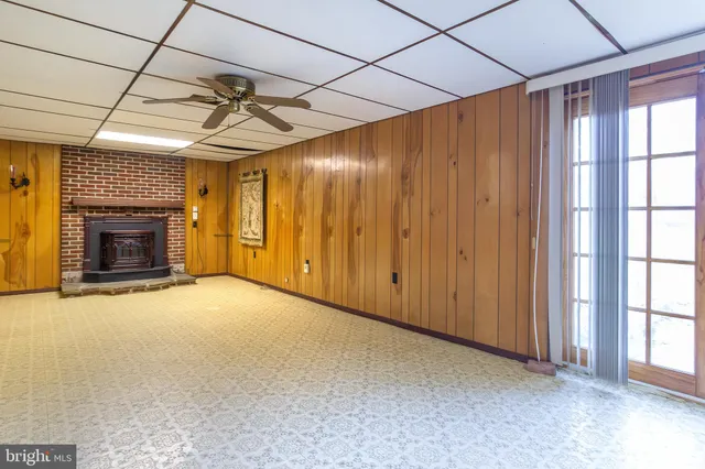 a view of empty room with a fireplace