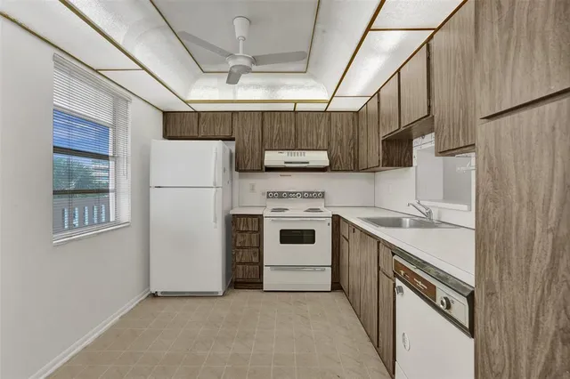 a kitchen with a stove cabinets and a refrigerator