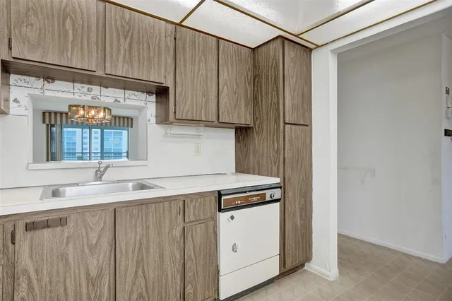 a kitchen with stainless steel appliances granite countertop a sink and a stove