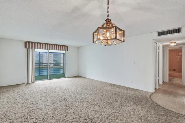 an empty room with windows and outdoor view