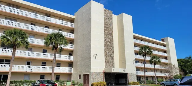 a view of a patio with dining table and chairs with wooden floor and fence