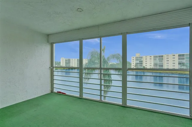 a view of a room with window and a ceiling fan