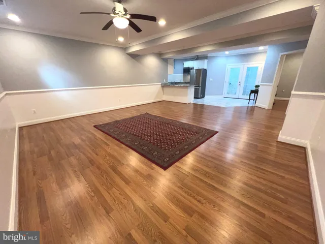 a view of an empty room and wooden floor