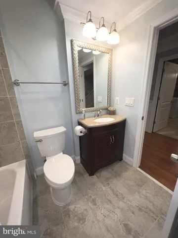 a bathroom with a sink toilet and mirror