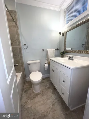 a bathroom with a toilet sink and a mirror