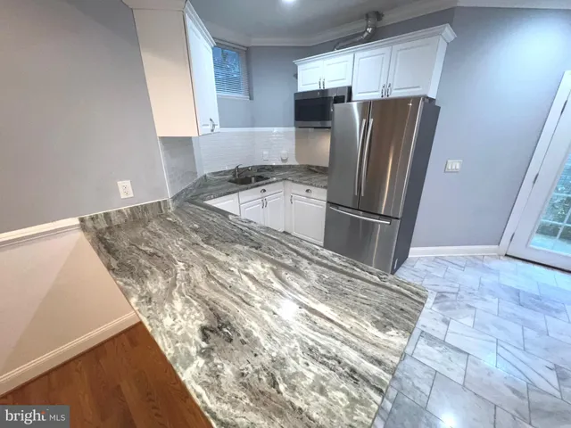 a kitchen with refrigerator and window