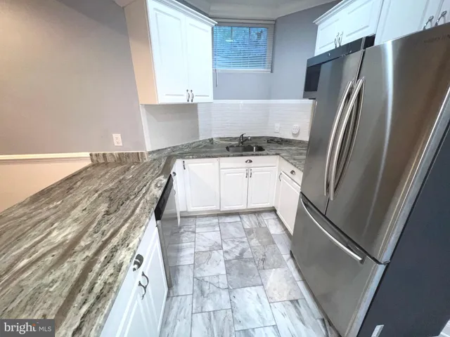 a kitchen with a refrigerator and a sink