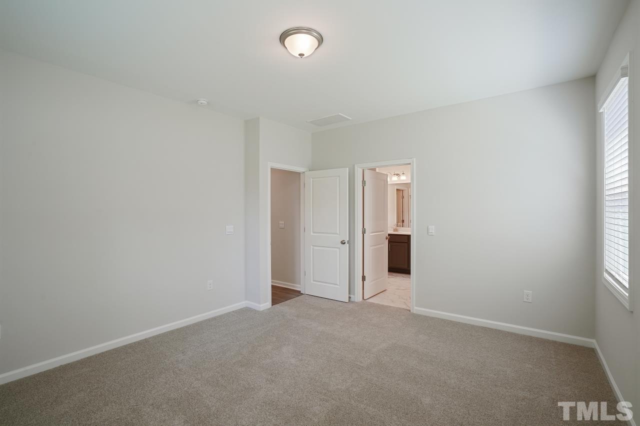 393 Madden Rose Loop Garner, NC 27529 - Photo 16 of 31 an empty room with windows