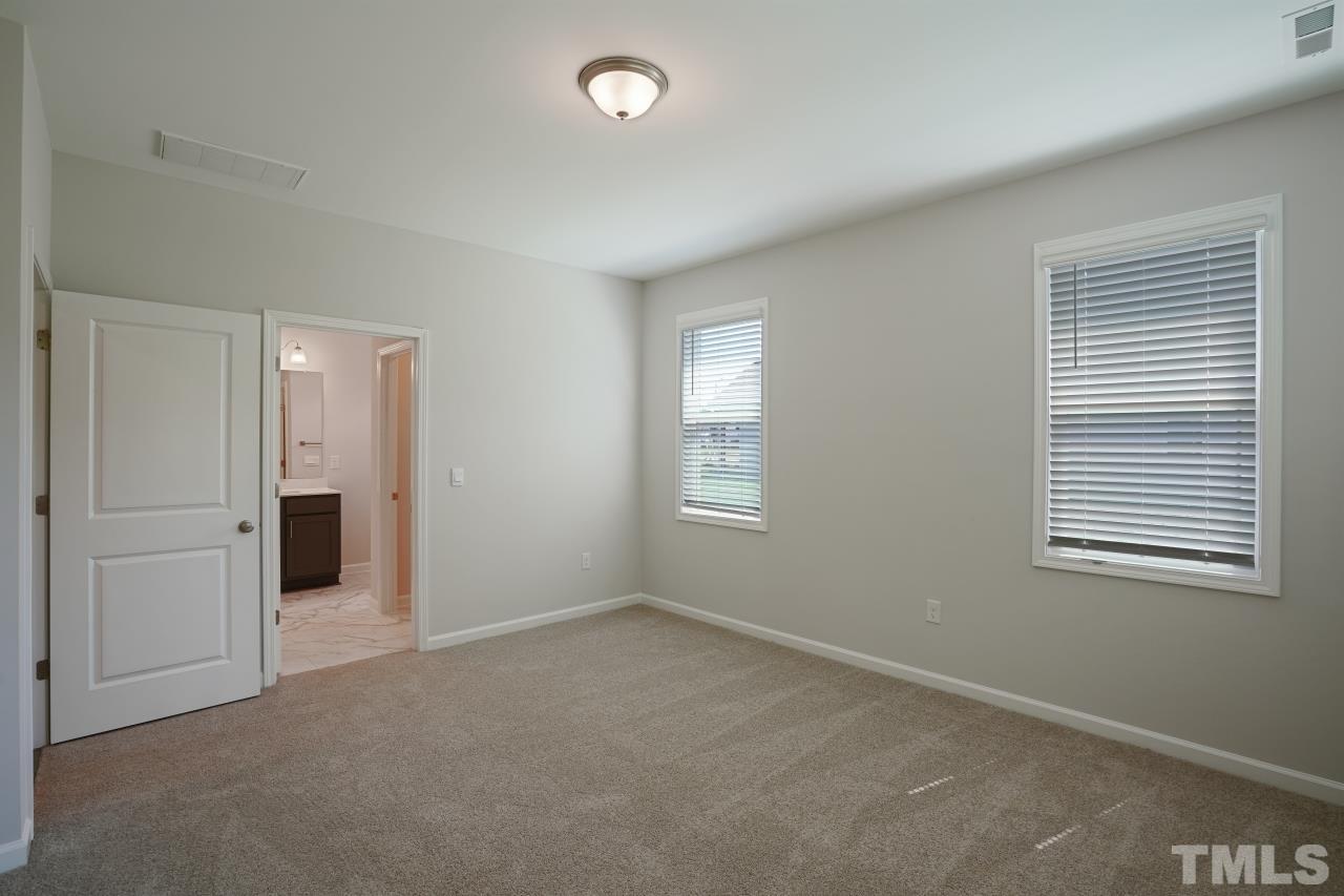 393 Madden Rose Loop Garner, NC 27529 - Photo 19 of 31 an empty room with windows