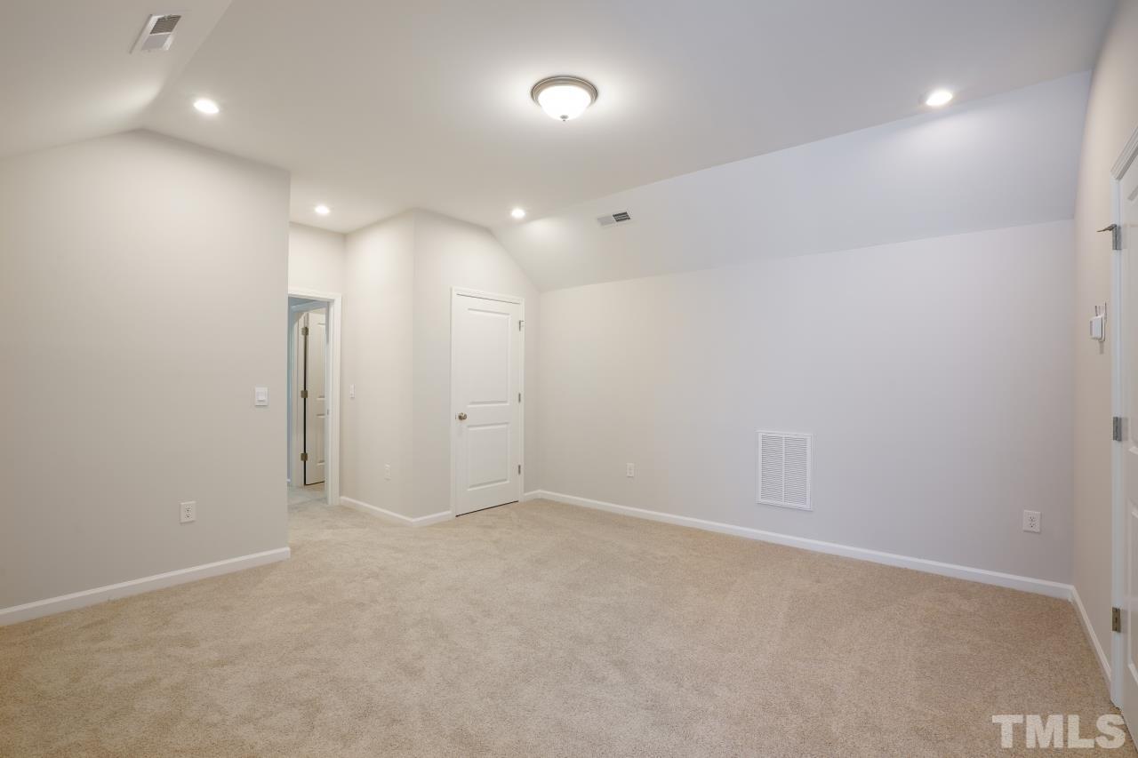 393 Madden Rose Loop Garner, NC 27529 - Photo 25 of 31 an empty room with an entryway