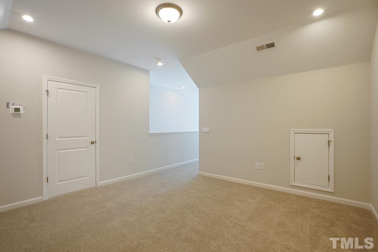 393 Madden Rose Loop Garner, NC 27529 - Photo 26 of 31 an empty room with an entryway