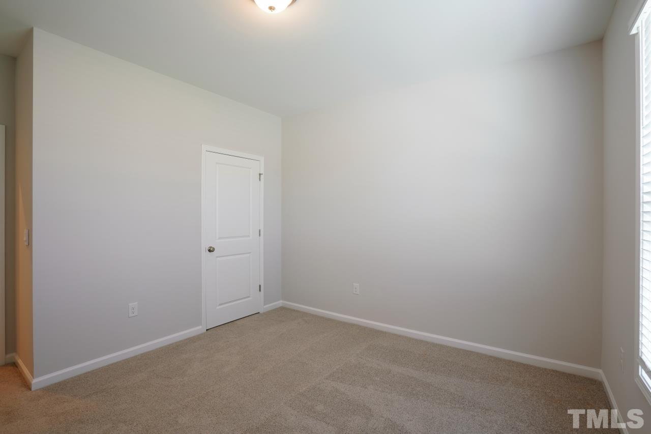 393 Madden Rose Loop Garner, NC 27529 - Photo 28 of 31 a room that has a window in it
