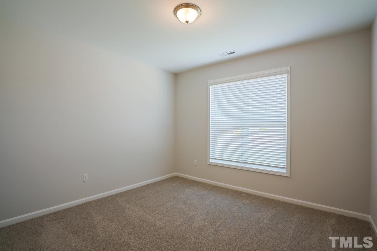 393 Madden Rose Loop Garner, NC 27529 - Photo 29 of 31 an empty room with a window