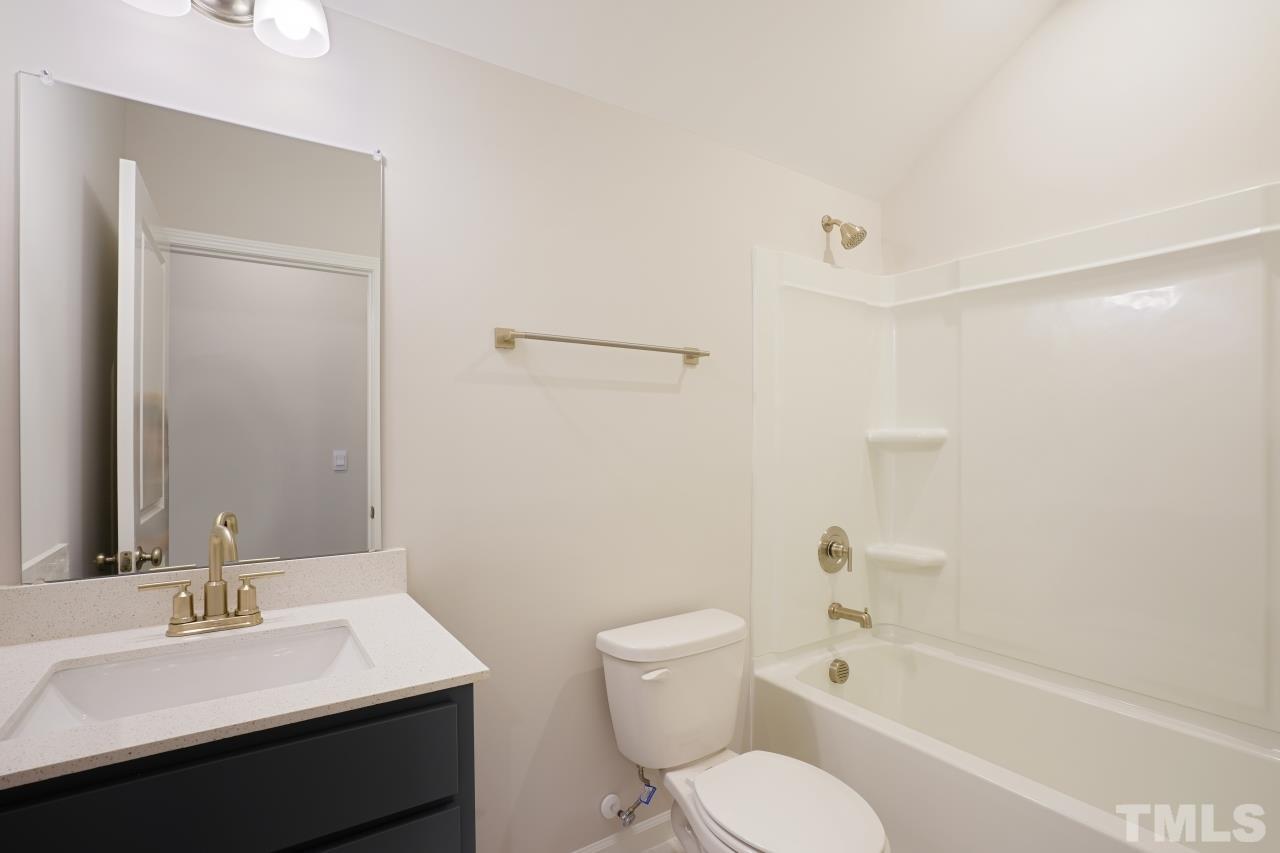 393 Madden Rose Loop Garner, NC 27529 - Photo 31 of 31 a bathroom with a toilet a sink and a bathtub