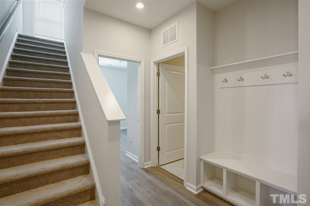 393 Madden Rose Loop Garner, NC 27529 - Photo 9 of 31 a view of a hallway with wooden floor and entryway