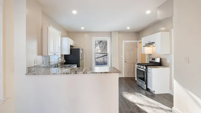a kitchen with stainless steel appliances granite countertop a stove and a sink