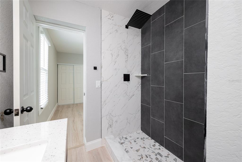922 Delaware Avenue St. Cloud, FL 34769 - Photo 14 of 31 a bathroom with a shower and a sink