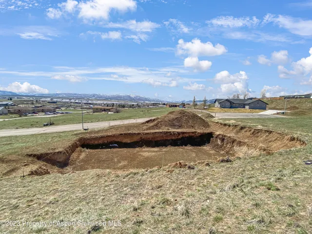a view of a lake with houses in the back