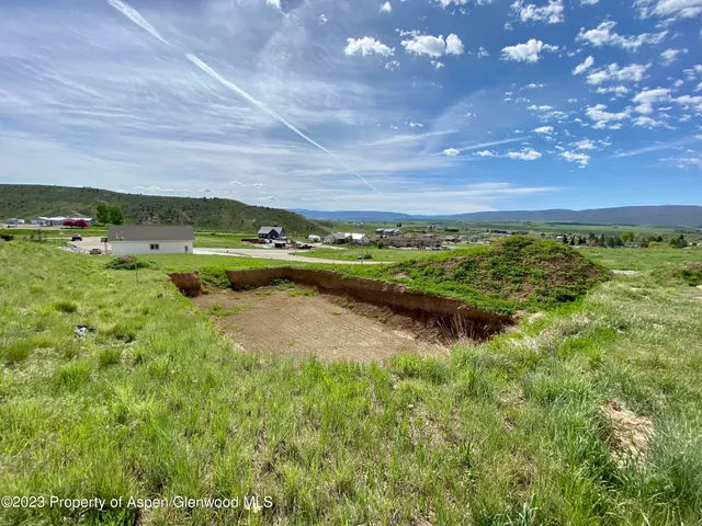 a view of a big yard with lots of green space