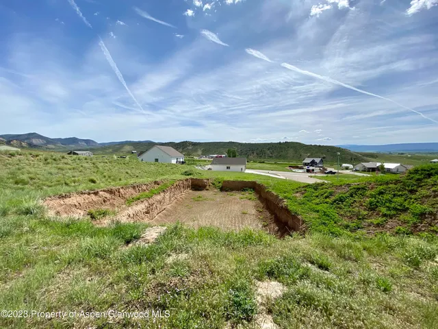 a view of a big yard with lots of green space