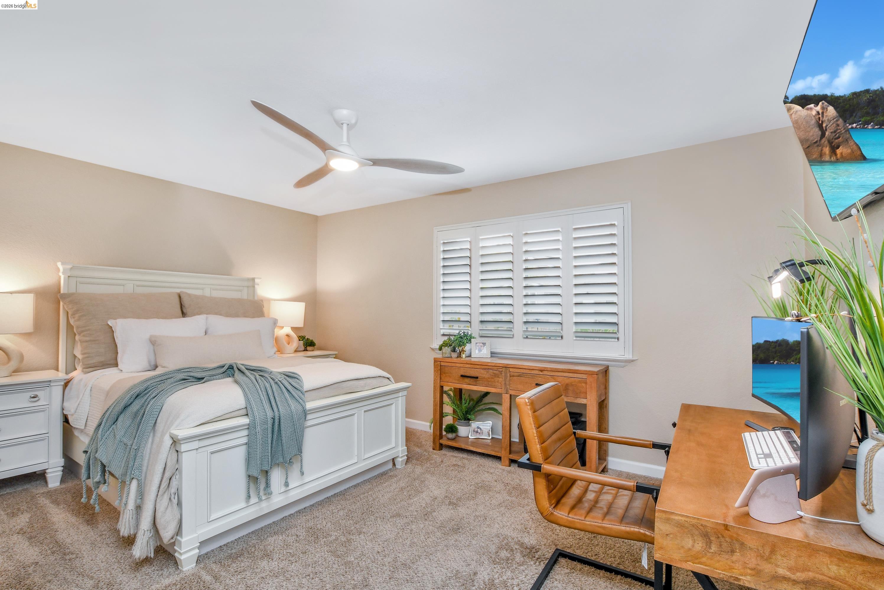 1432 Willow Lake Road Discovery Bay, CA 94505 - Photo 20 of 40 Carpeted room featuring a ceiling fan with integrated lighting, a window with plantation shutters, and a wood-finish desk with a black metal frame