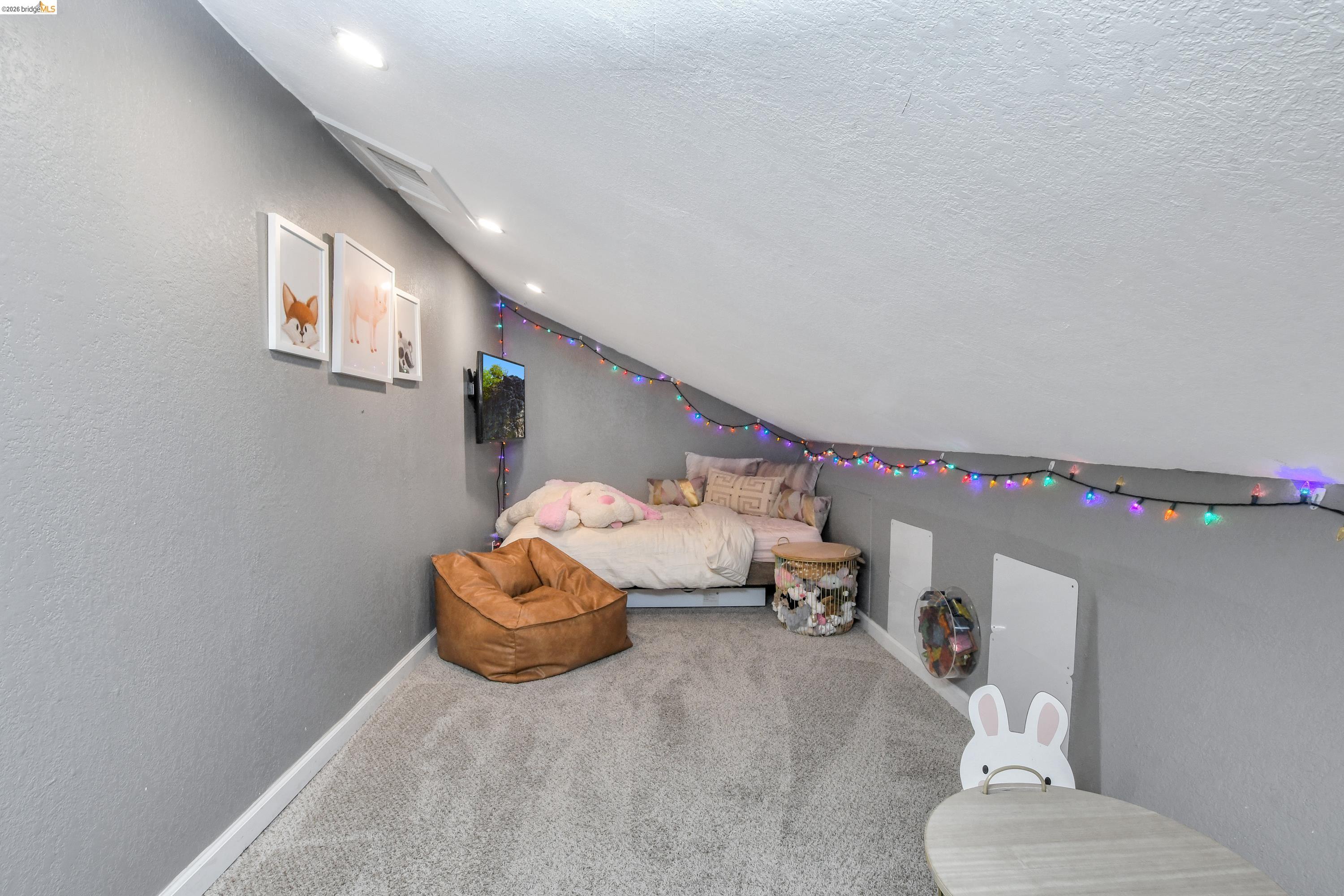 1432 Willow Lake Road Discovery Bay, CA 94505 - Photo 23 of 40 Carpeted attic space featuring sloped ceilings, recessed lighting, and wall-mounted access panels