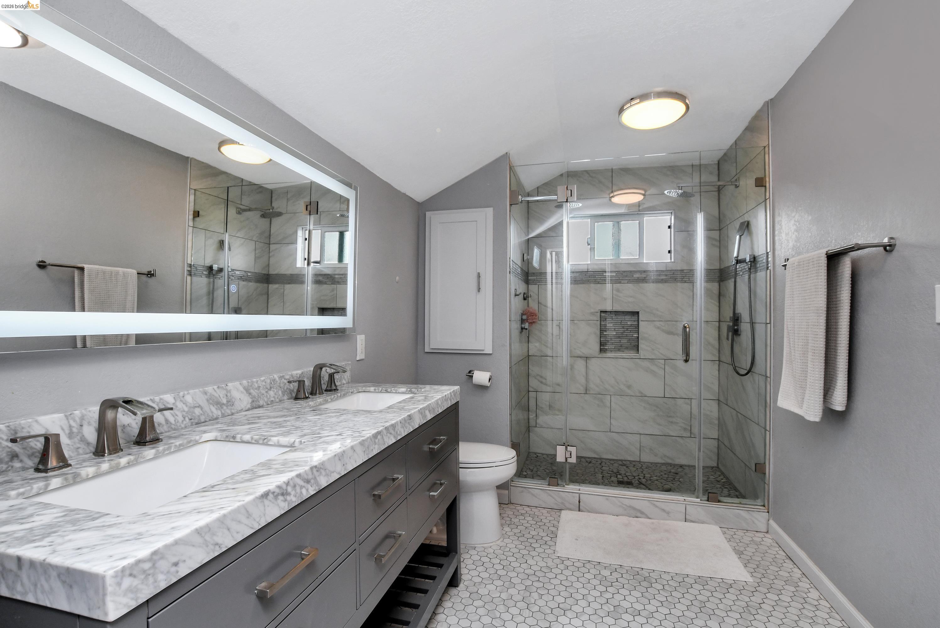 1432 Willow Lake Road Discovery Bay, CA 94505 - Photo 30 of 40 Dual vanity with marble-finish countertop, undermount sinks, and bronze-finish fixtures