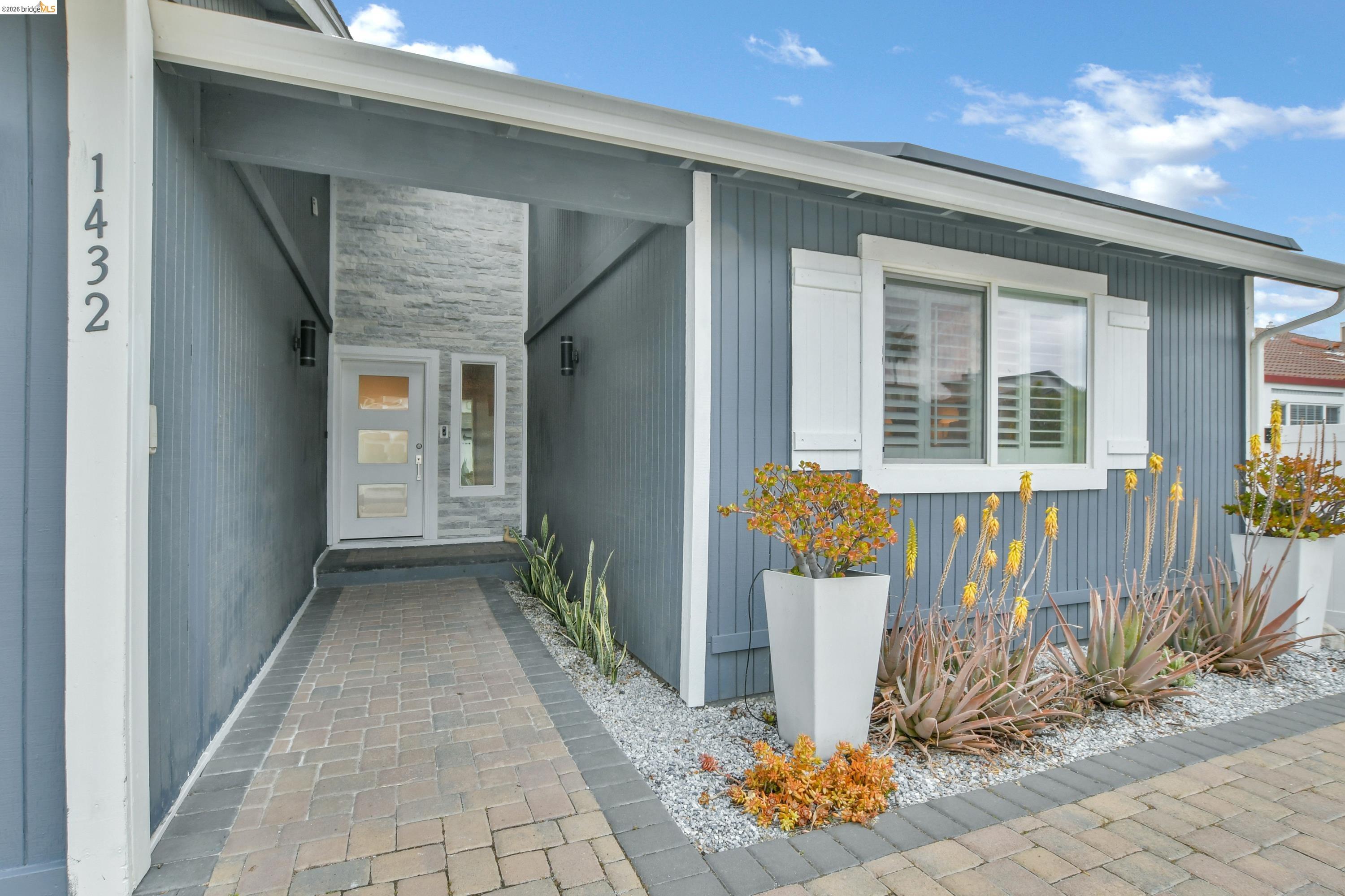 1432 Willow Lake Road Discovery Bay, CA 94505 - Photo 3 of 40 Modern exterior with vertical siding and a sheltered entryway
