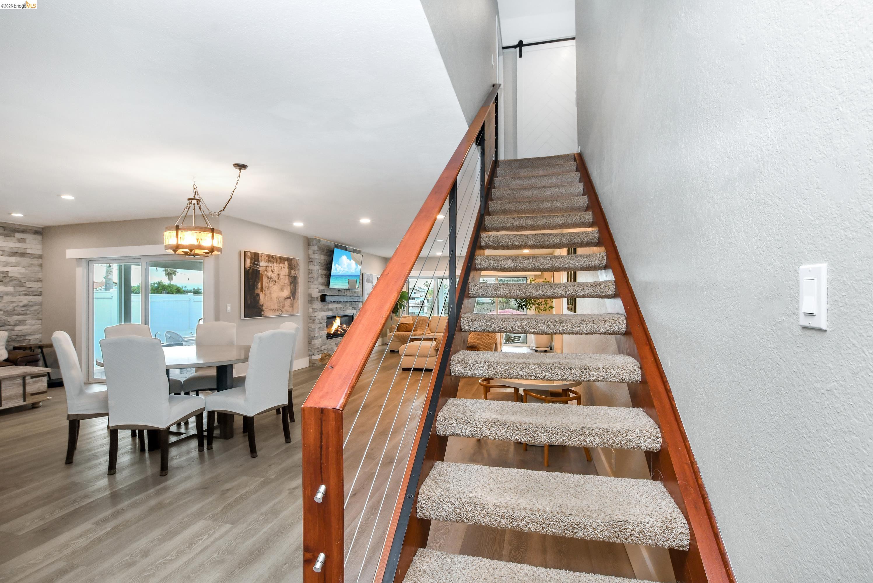 1432 Willow Lake Road Discovery Bay, CA 94505 - Photo 5 of 40 Carpeted staircase with wood-finish handrails and cable railing